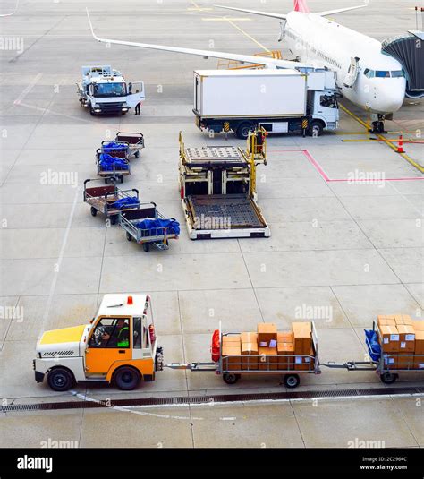 a baggage carrier at an airport figgerits